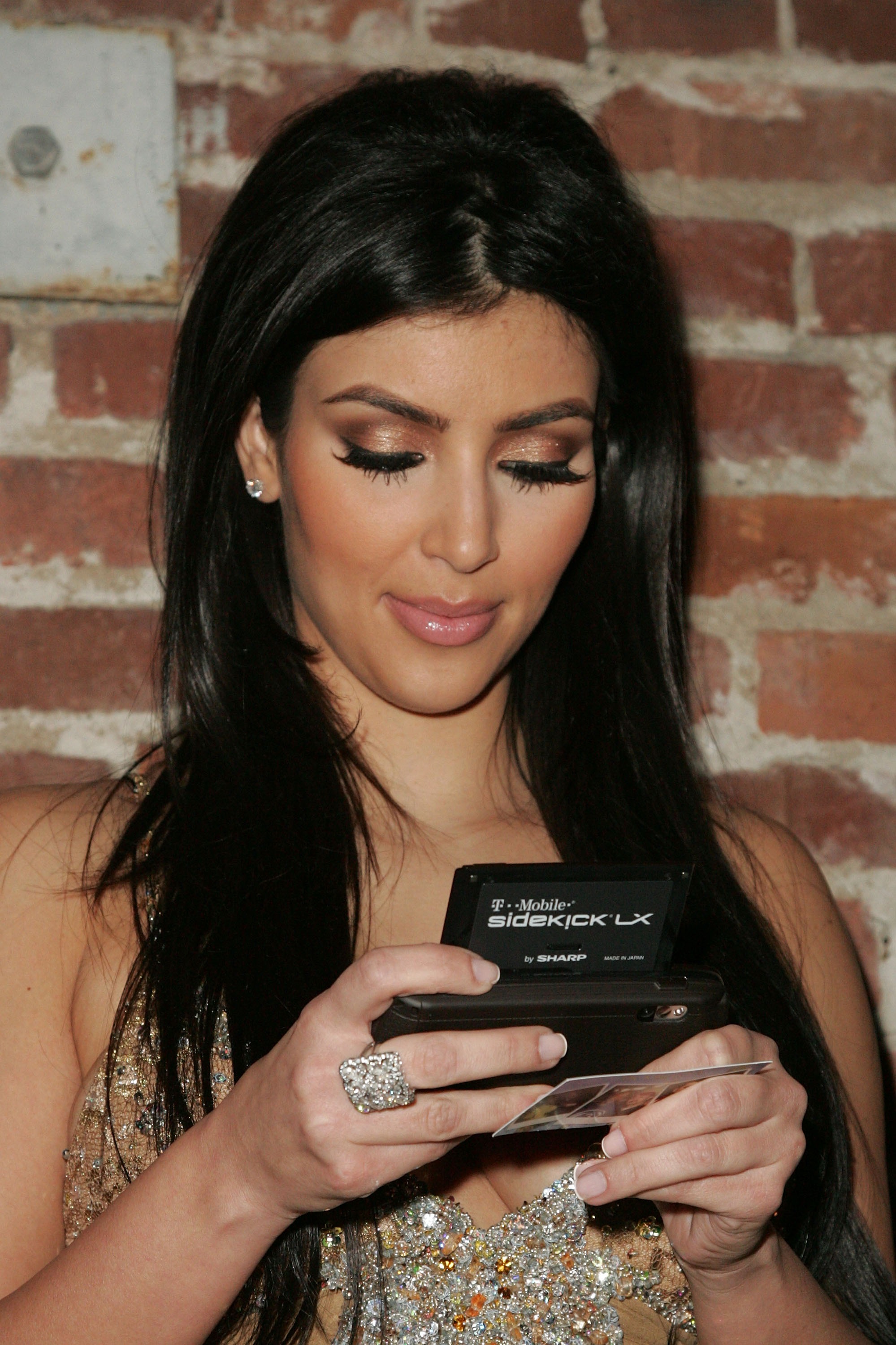 Kim Kardashian holding a Sidekick LX