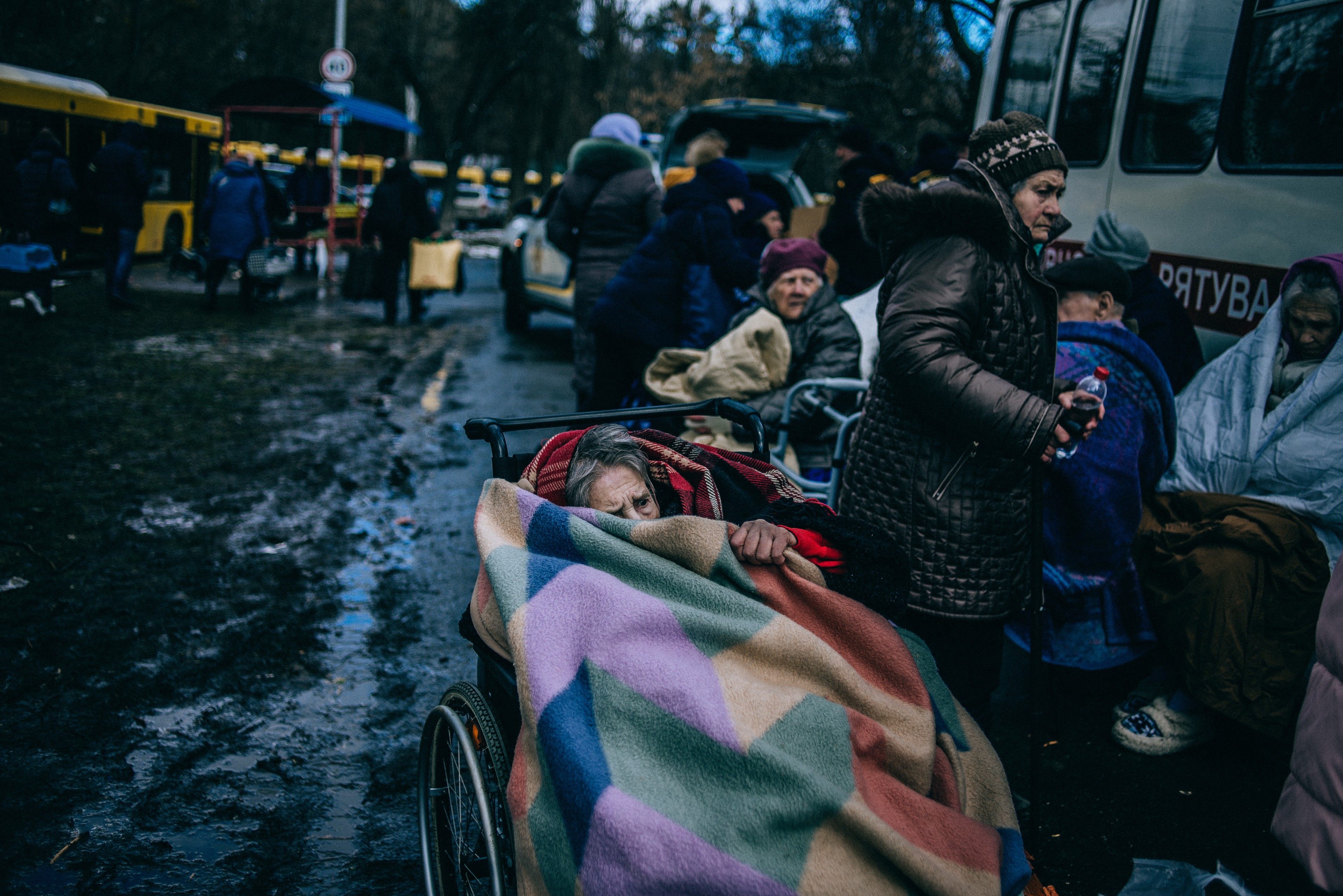 An elderly woman shelters under a blanket after being evacuated from Irpin, near Kyiv, last month.