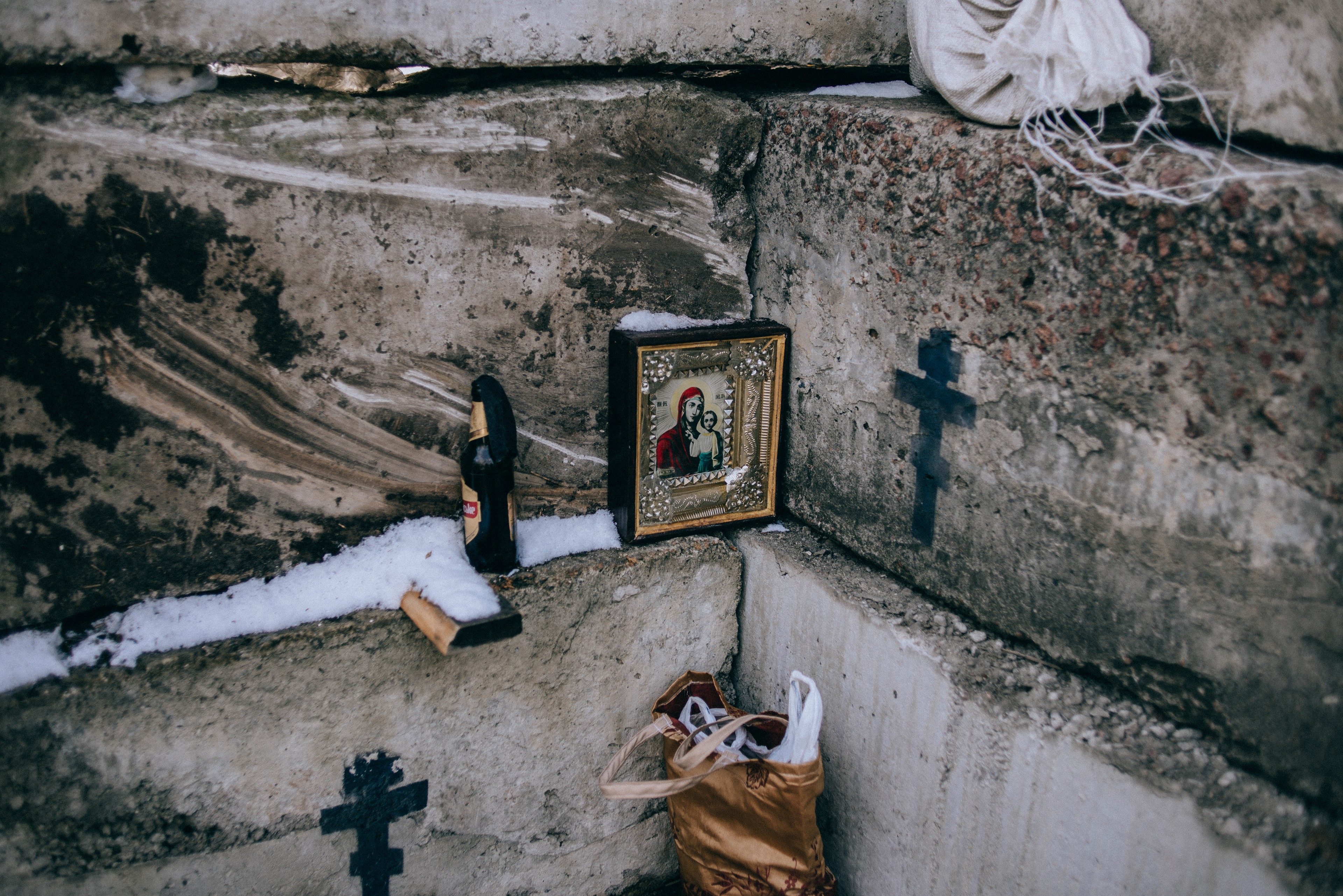 An icon sits near a Molotov cocktail at a checkpoint outside Kyiv.