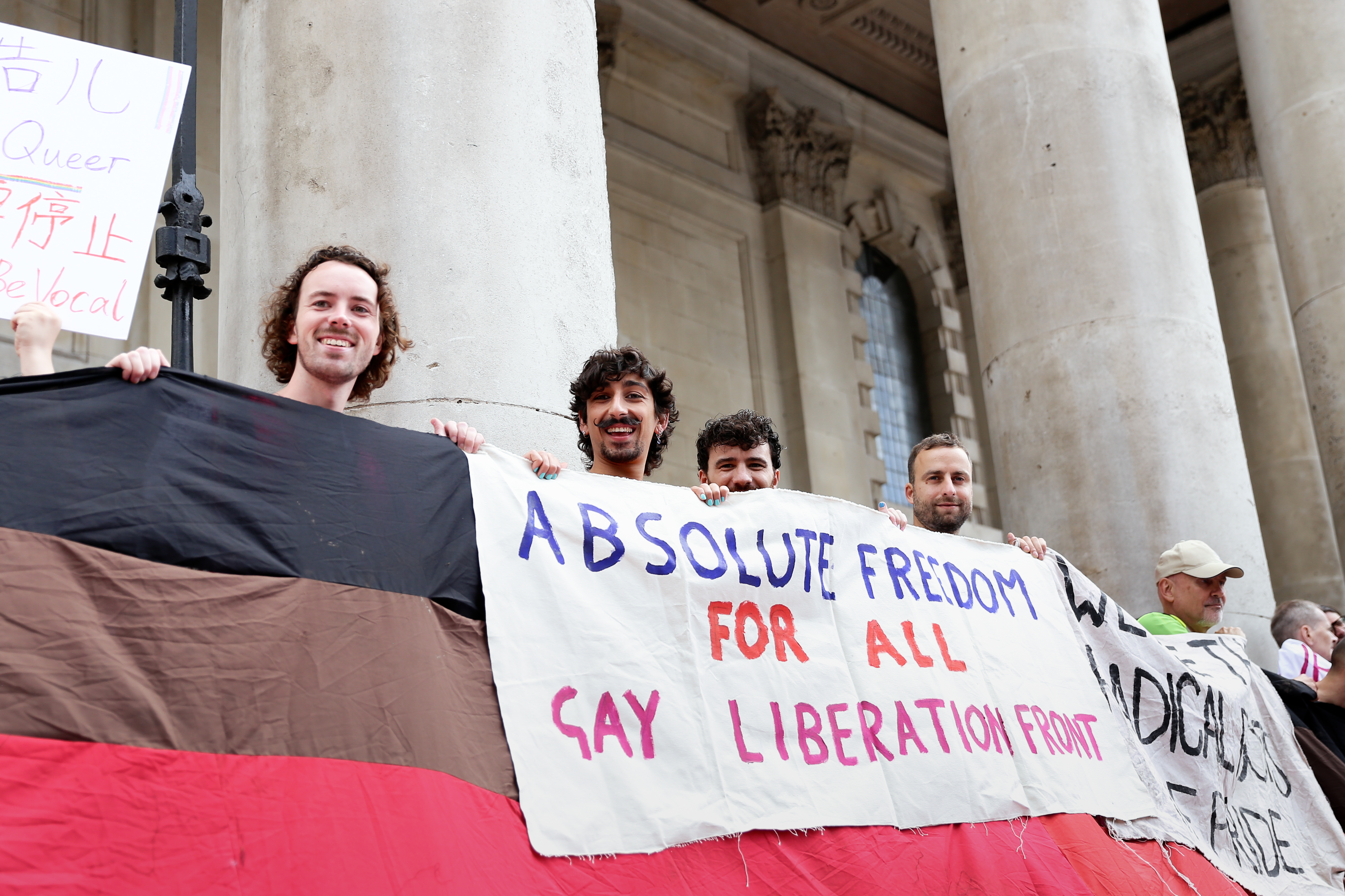 People holding up banner saying