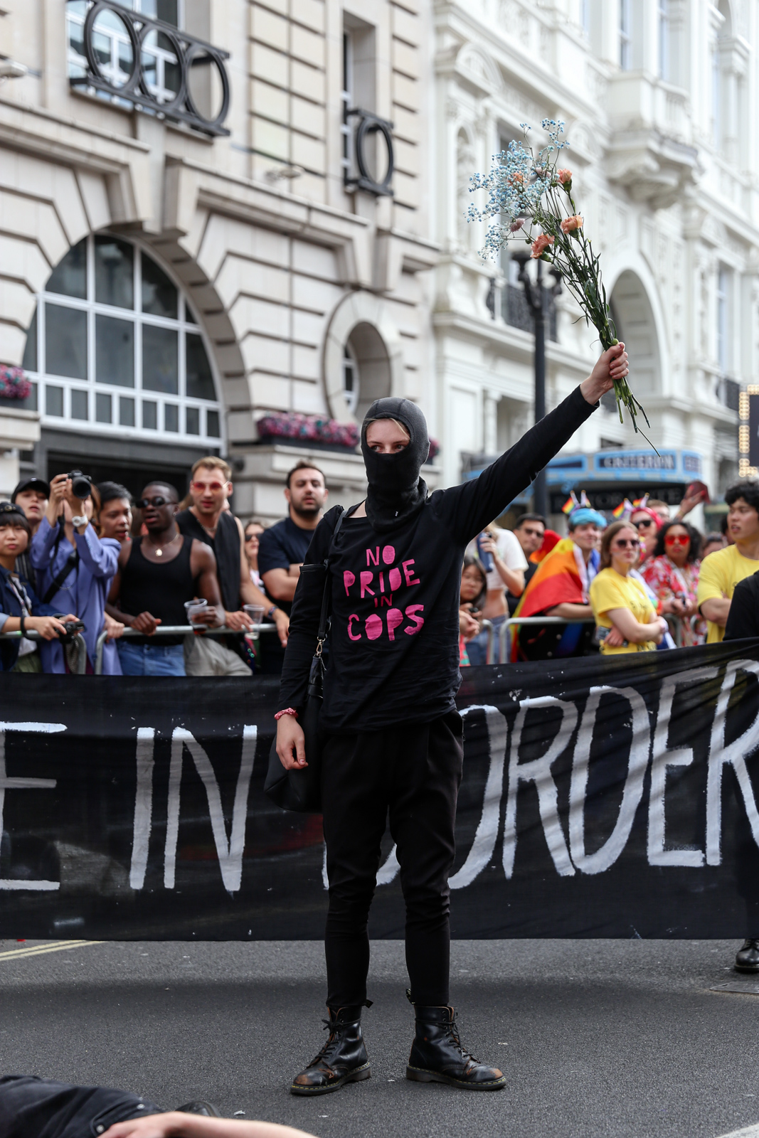 London Pride 2022: A Lesbian and Gays Support the Migrants activists in a balaclava