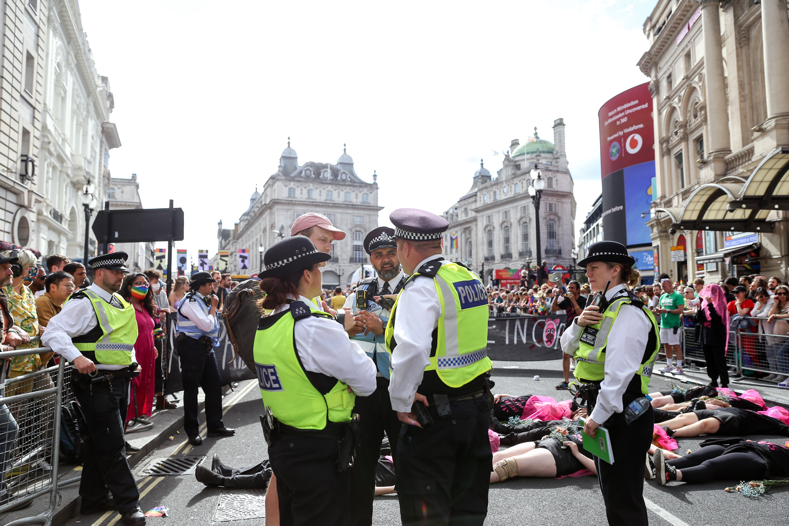 London Pride 2022: Met Police officers talking to Lesbian and Gays Support the Migrants activist