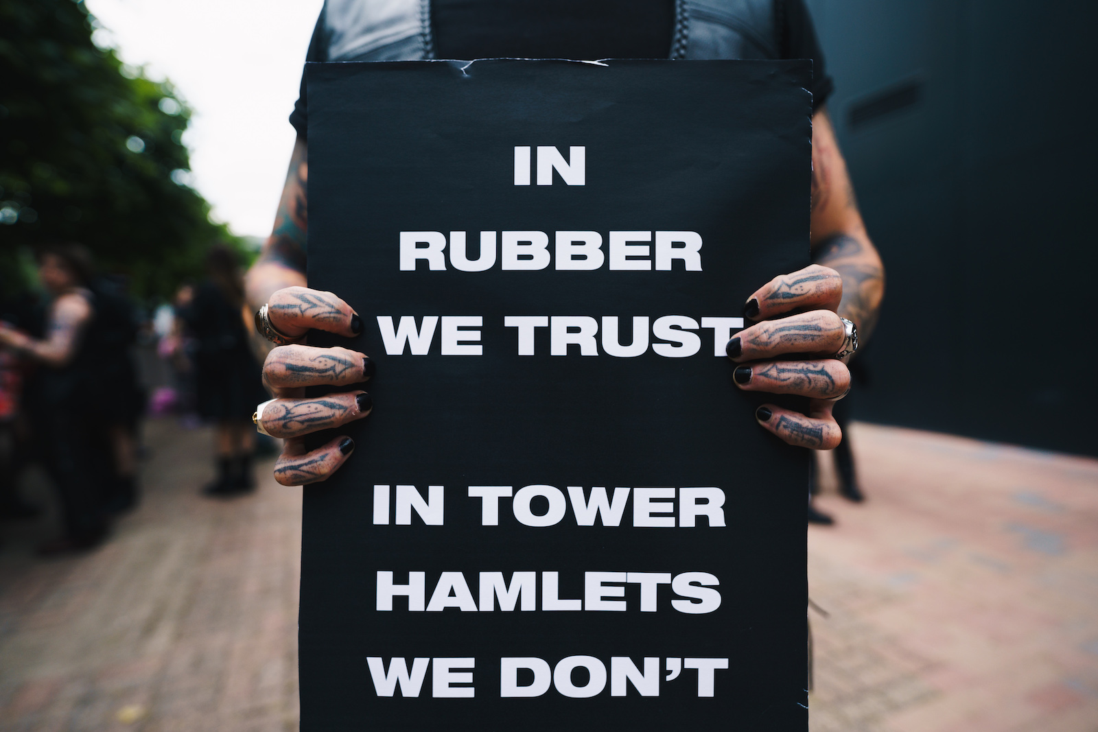 A protestor holding a sign at the 'Safe kink spaces' protest in east London