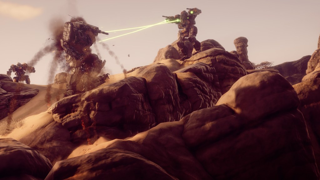A mech stands at the top of a hill, firing a pair of lasers into a larger mech below it, which is exploding.