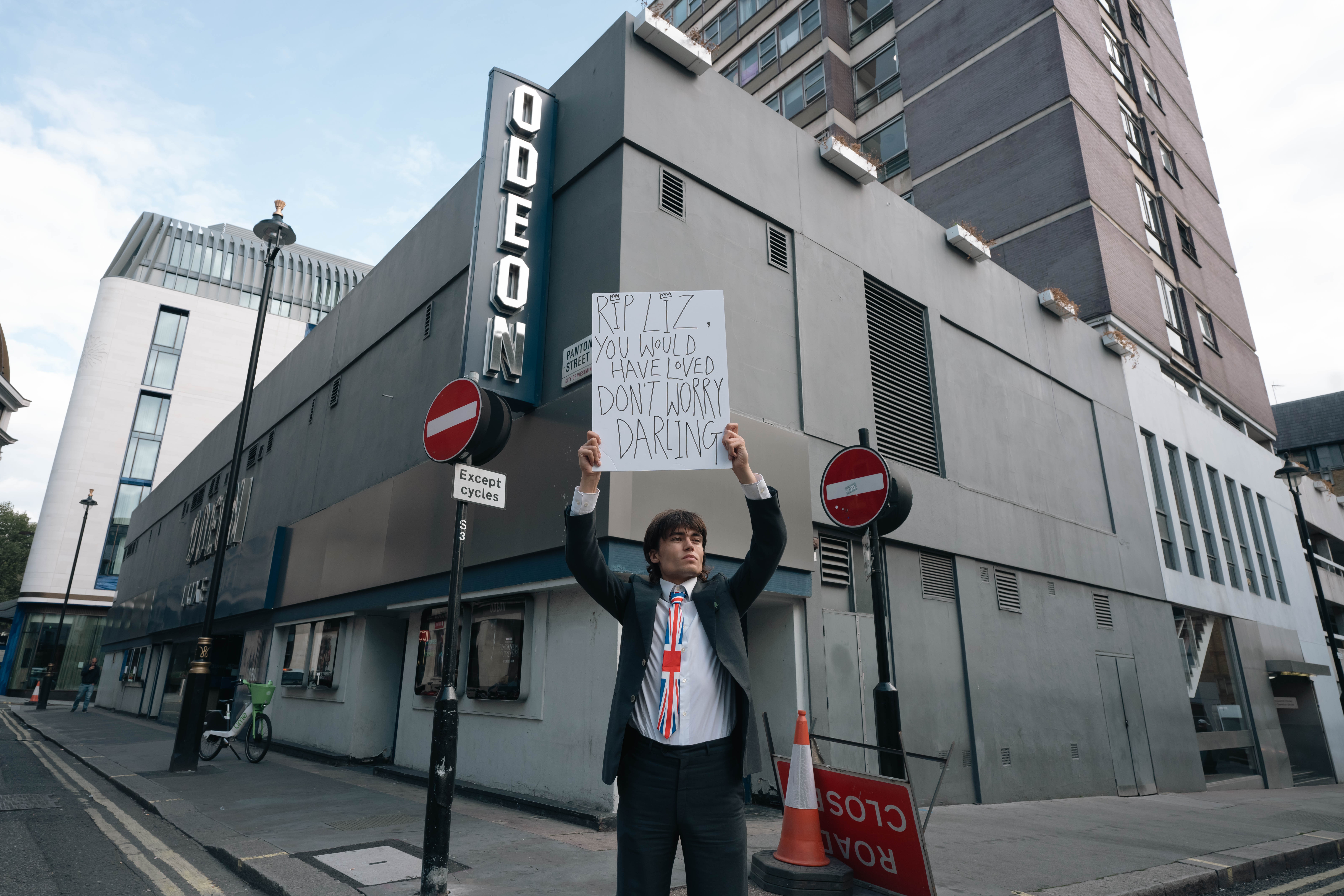 Author holding up sign that reads