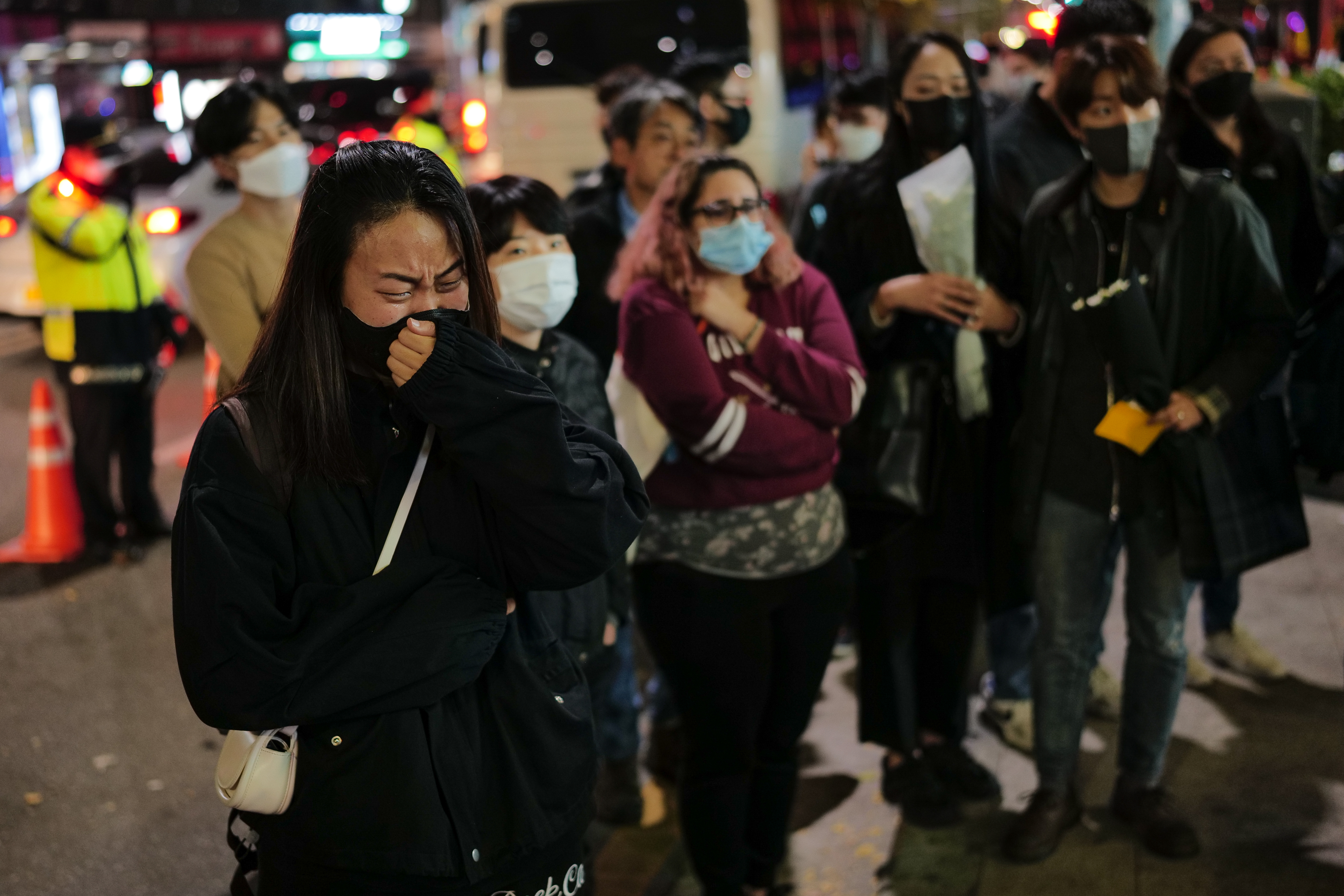 Grievers pay their respects at a memorial site located just outside of Itaewon subway station and a few meters away from the main crush site. Photo: Chris Jung/NurPhoto via Getty Images