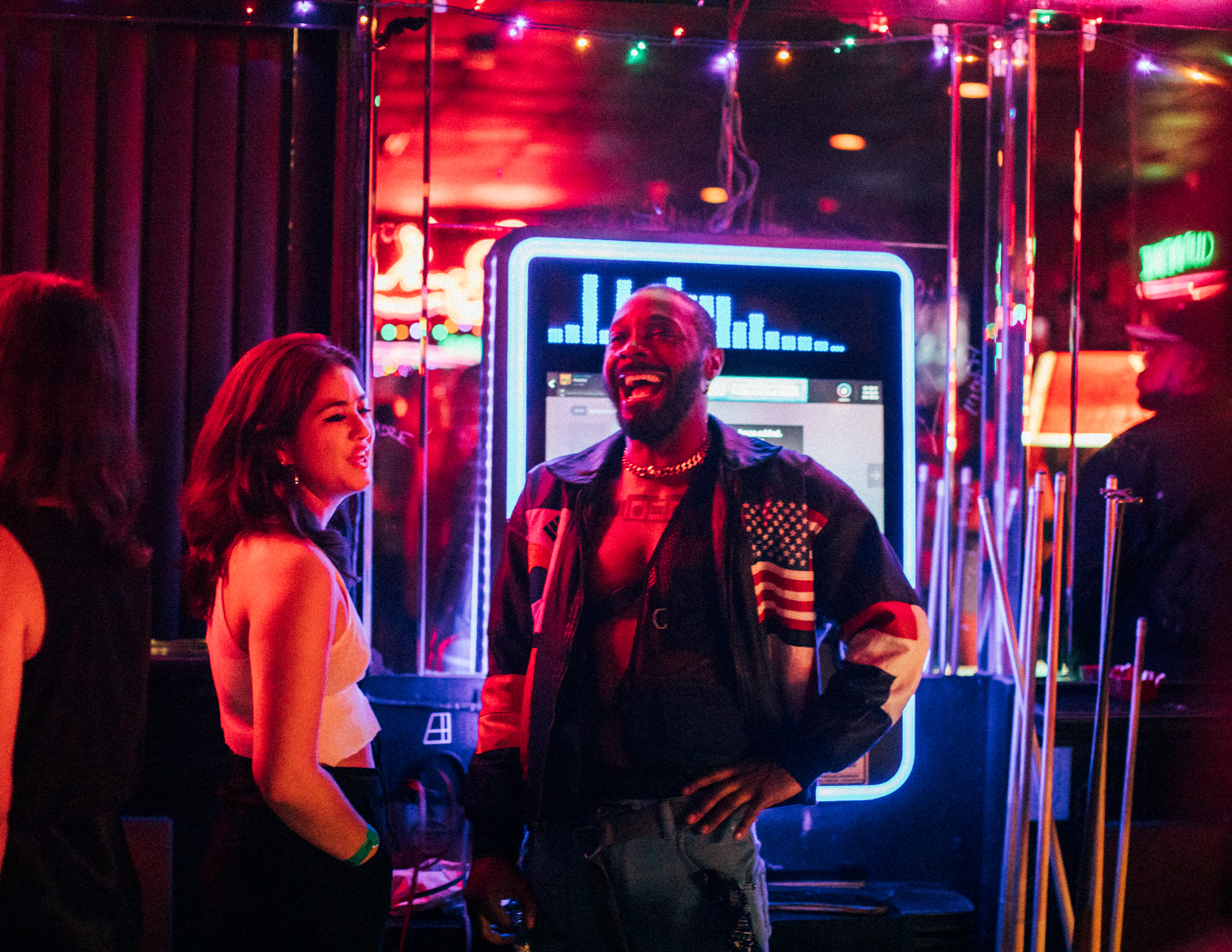 JPEGMAFIA and writer Katie Way laughing by the bar's jukebox