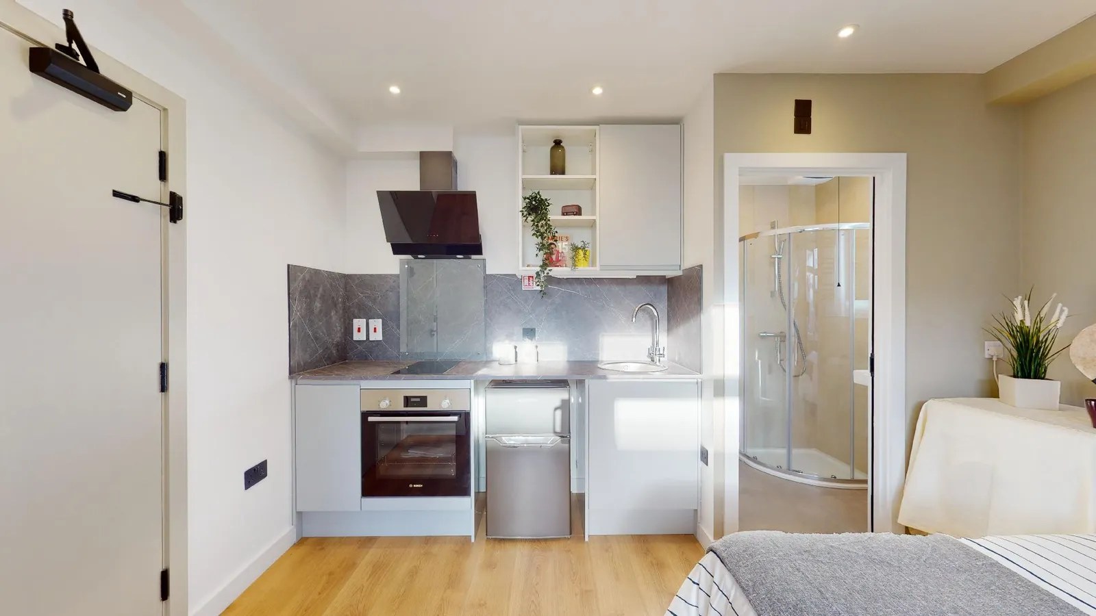 The kitchen in the bedroom of one-bed studio for rent in Acton, London