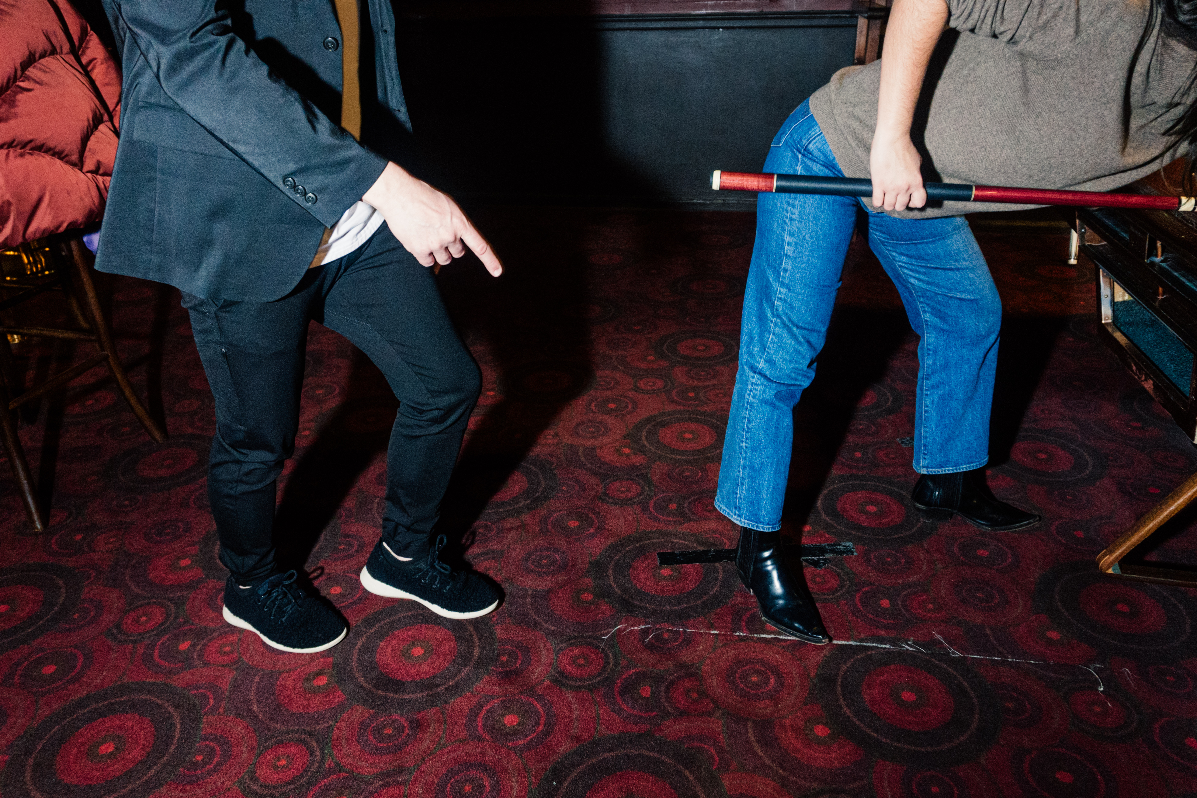 The image just shows Hohmann and Katie's legs, as Hohmann points towards Katie's legs as she positions herself for a shot.