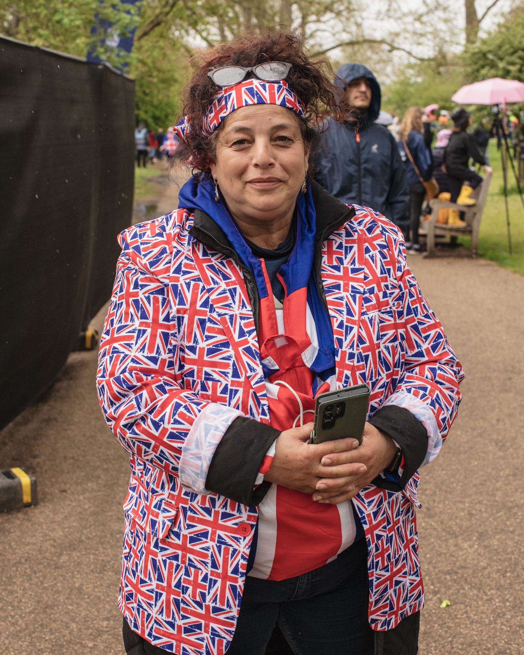 Coronation of King Charles II, London: A woman holds phone in Union Jack blazer