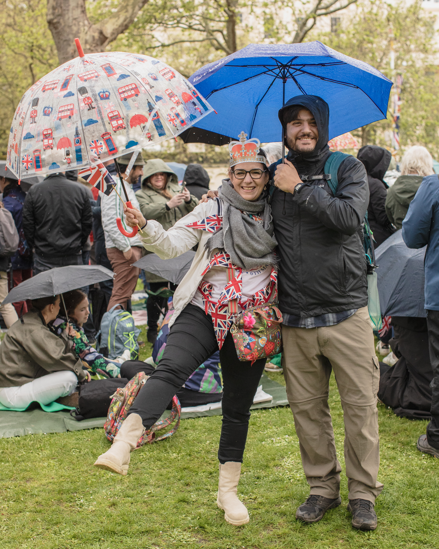 Coronation of King Charles II, London: A couple holding umbrellas on lawn
