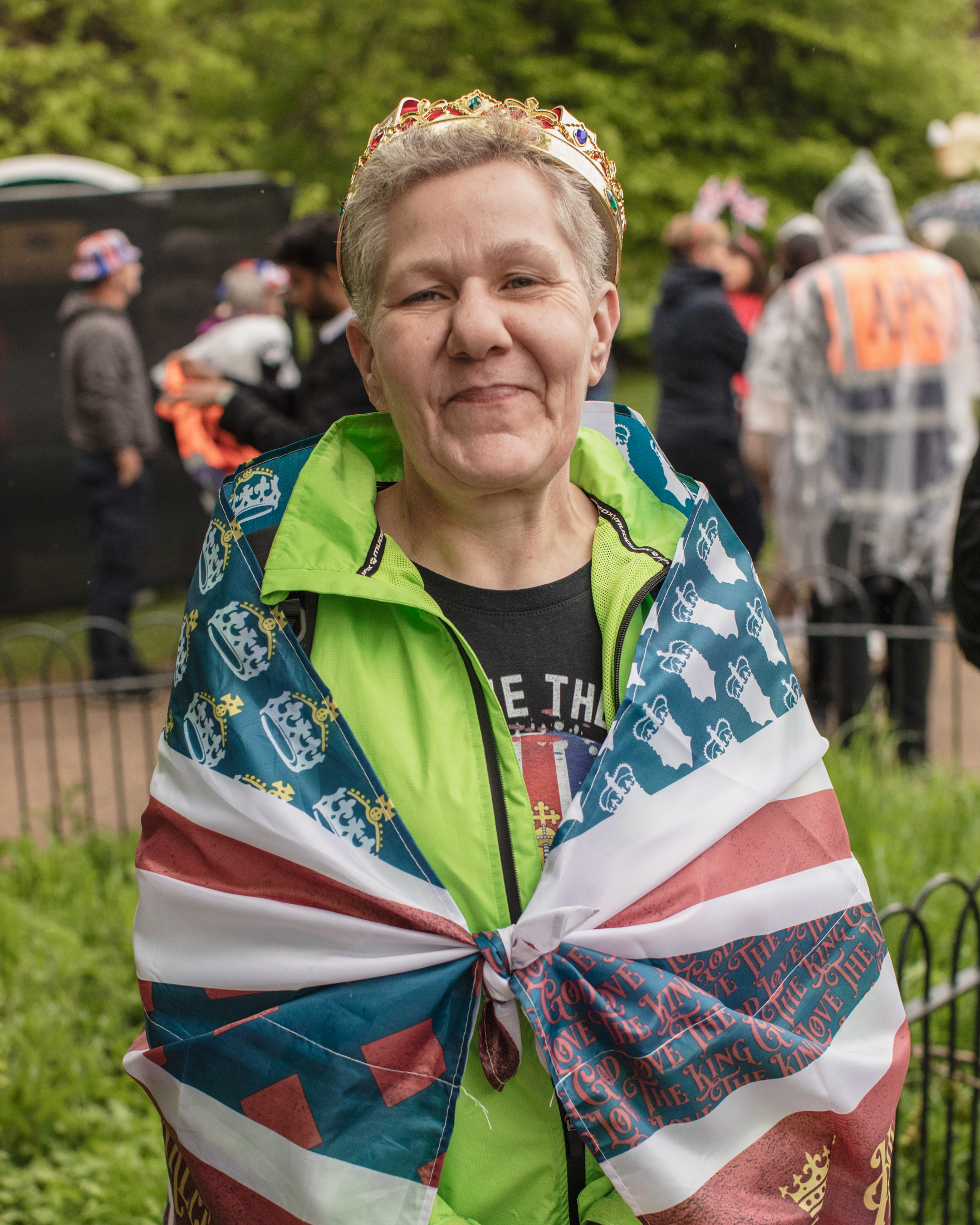Coronation of King Charles II, London: A woman wearing crown wrapped in UK flag