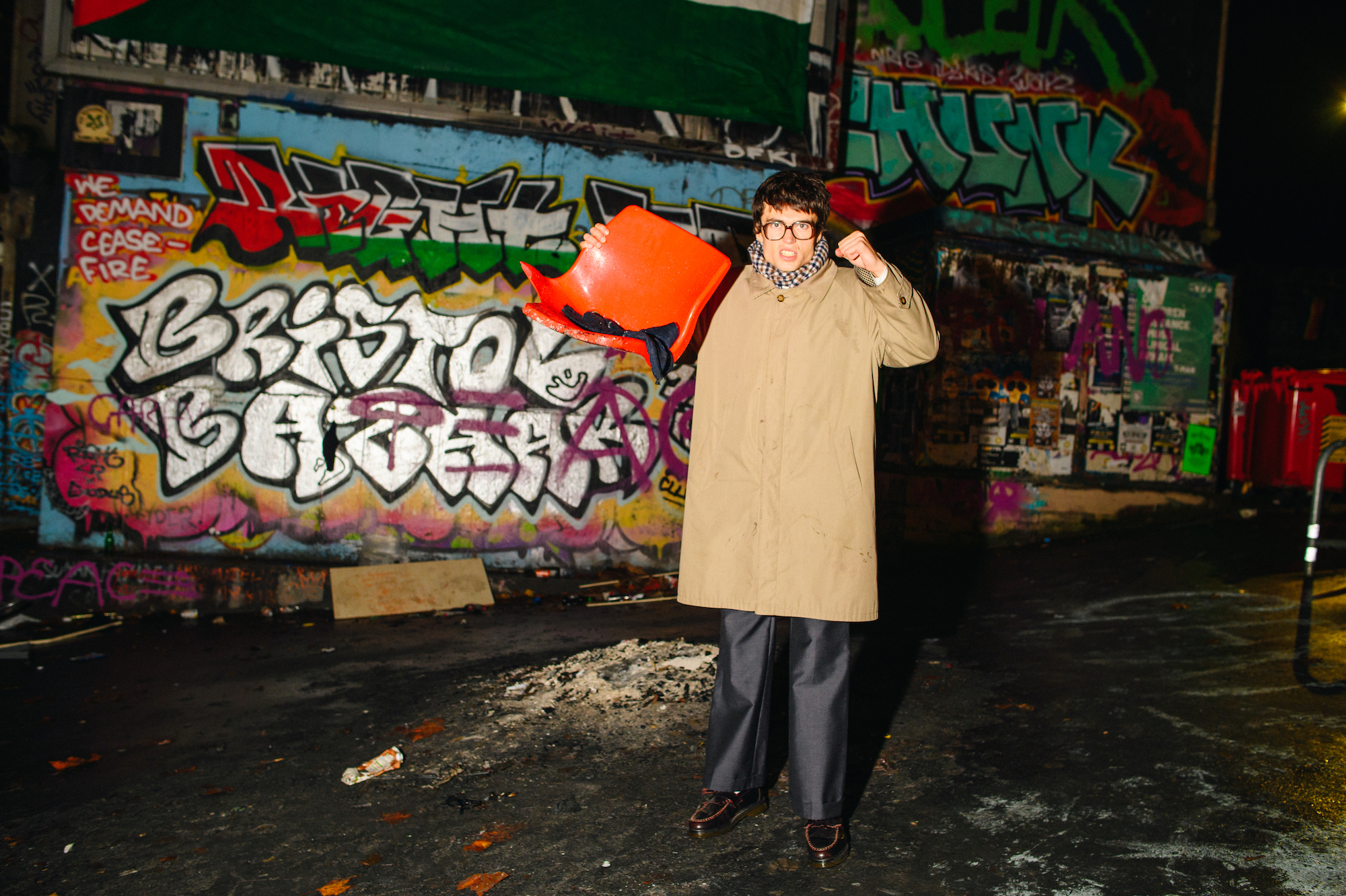 Man holding remnants of chair on Turbo Island, Bristol