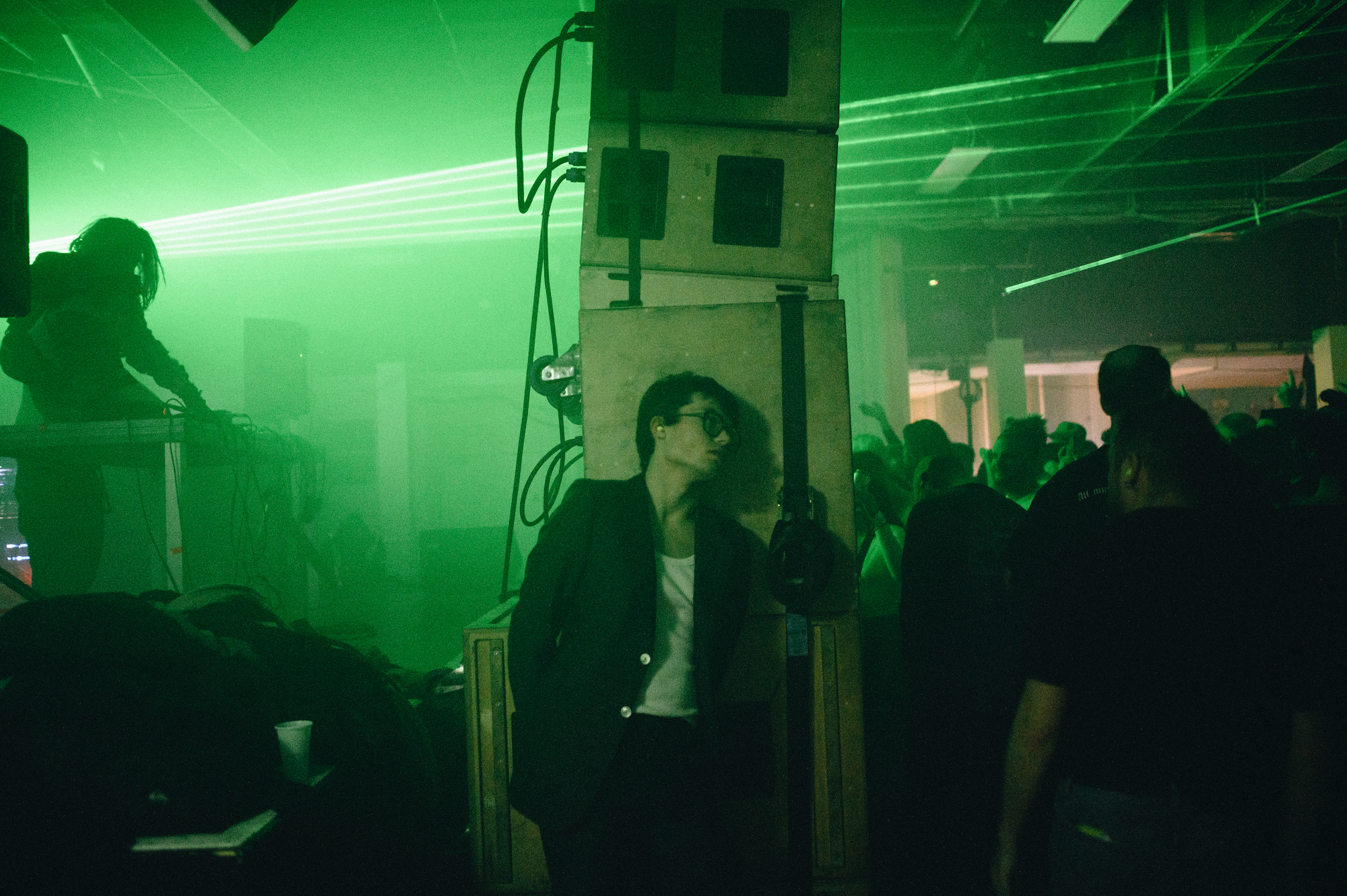 A man leaning against a pile of speakers at Trinity Centre, Bristol