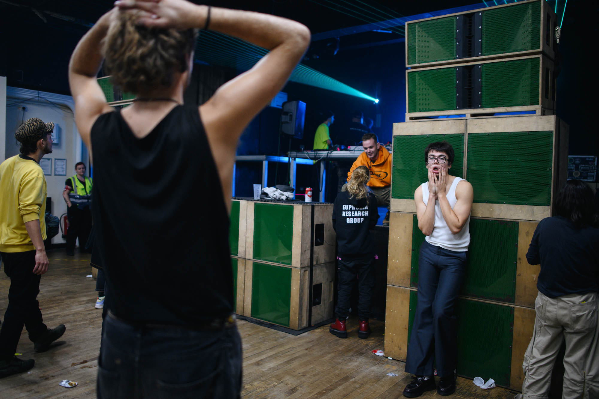 A man in glasses looking tired against wall of speakers at Trinity Centre, Bristol
