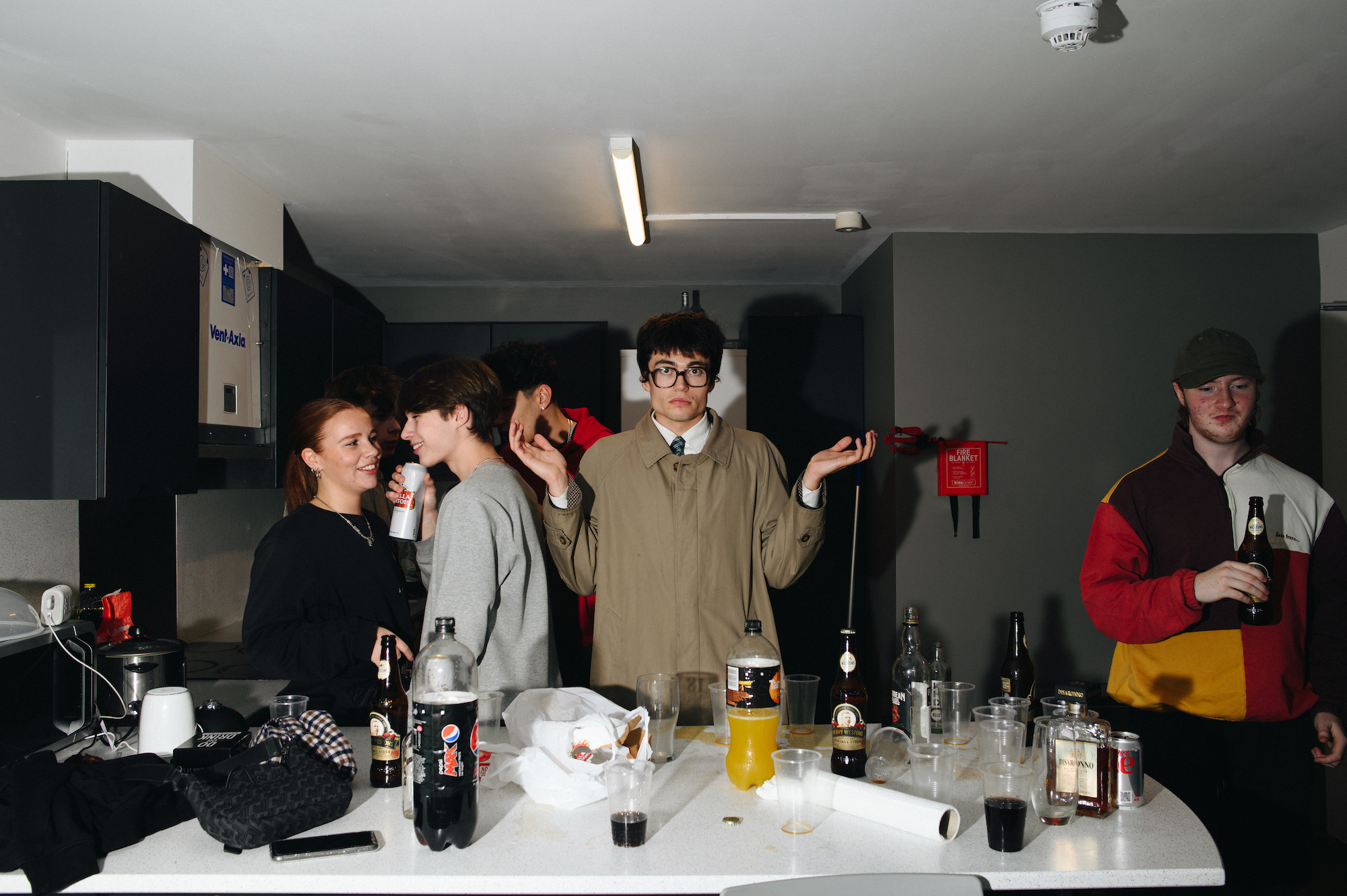 Man in glasses shrugging at Bristol student party