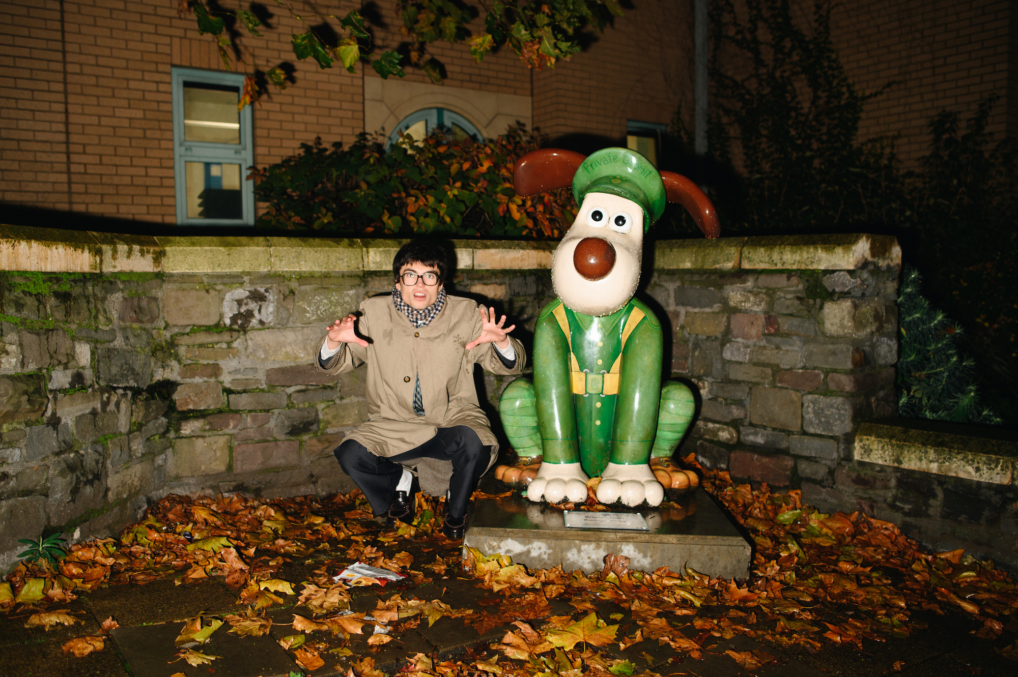 Man posing next to Gromit statue in Bristol